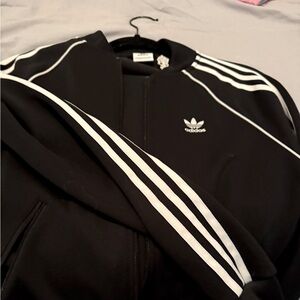Adidas tracksuit two piece zip up front. White stripes down arm and leg.